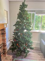 Entire artificial Christmas tree with stand and light string