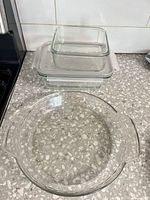 Round glass pie dish and two square glass storage containers stacked