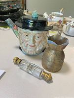 Group shot showing teapot, vase and scent bottle