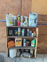 Full view of wooden shelf with all automotive fluids, sprays and accessories