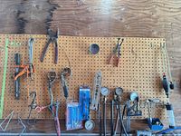 Pegboard view showing pliers, clamps, gauges, packaged adapters and pump bulb