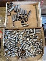 top view of two boxes filled with assorted chrome sockets and accessories