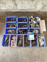 Top view of all blue bins with assorted hardware pieces
