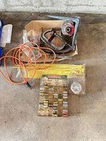 All items grouped showing fuse display, extension cord, zip ties, hardware, clamp, discs and wrenches in box