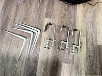 Overview of 3 bottle pourers and 4 shelf brackets