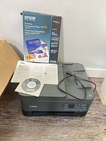 Canon PIXMA TR7000 printer with power cable, paperwork, CD-ROM, Epson paper pack