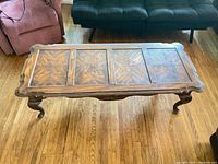 Full view of wooden coffee table with cabriole legs