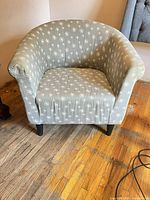 Front view of gray floral tub armchair