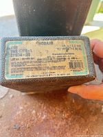 Close-up of container label showing Hobart, AWS E7018-1, 1/8 in (3.2 mm) details