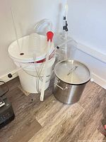Overall group: buckets, carboy, stock pot, siphon tube