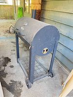 Full view of grill on stand with wheels