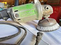 Makita GA7911 angle sander side view showing brand name and power cord