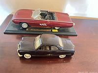 Both diecast cars side by side on table