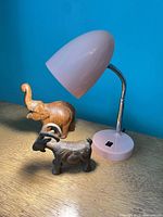 Lamp, wooden elephant, cast iron ram on tabletop