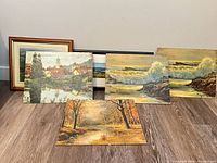 Group shot of all six artworks standing against wall