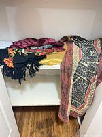 All five textiles folded on shelf
