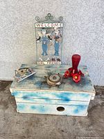 All items grouped: wooden box, signs, feeder, barometer