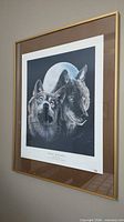 Framed lithograph showing full artwork in gold frame and brown mat