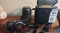 Camera body, telephoto lens, bag with tag visible