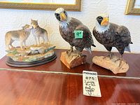 All three figurines on tabletop showing relative sizes and condition