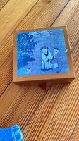 Closed wood holder with top coaster showing Asian scene