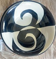 Top view showing black and white swirl pattern and rim chips