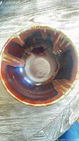 Top view showing interior brown and amber glaze with green rim