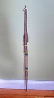 Full view of bamboo arrow bundle with hanging cord
