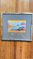 Full view of framed painting showing frame, mat and artwork