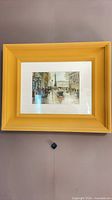 Full view of framed watercolor in yellow-gold frame