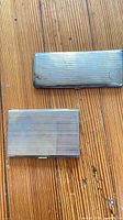 Front view of both silver-plated cases closed