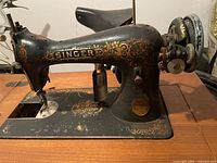 Left side view of Singer sewing machine in cabinet opening