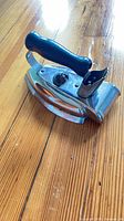 Full view of iron showing chrome body and black handle