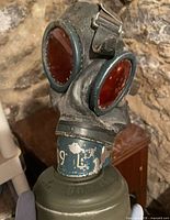 gas mask front view showing lenses, connector, filter