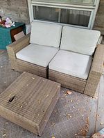 Loveseat with cushions and matching square table on patio