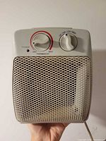 Front view showing metal mesh grille and control dials
