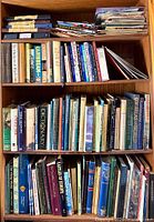 Four shelves filled with books of assorted sizes and topics