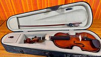 Violin, bow and interior of shaped case
