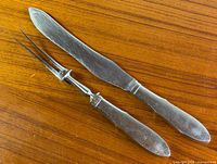 Knife and fork full view on wood surface