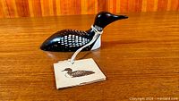 Overall view of the painted wood loon with hang tag attached