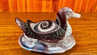 Left side view of assembled duck on nest dish