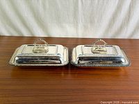 Pair of silverplate covered entrée dishes side by side