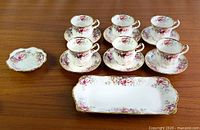 Full set: six cup-saucer pairs, nut dish, rectangular tray on table