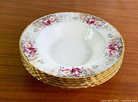 Stack of five Autumn Roses soup bowls showing rim decoration and gold trim