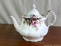 Left side view of Royal Albert Autumn Roses teapot showing floral design, spout and handle