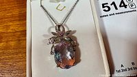 Front view showing pendant design, gemstone, chain