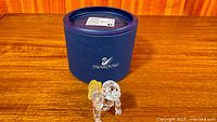 Front view of Swarovski gorilla figurine beside blue Swarovski box