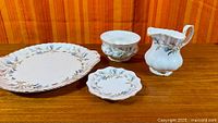 all four Brigadoon pieces: platter, sugar bowl, small dish, creamer