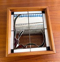 Full view of stained glass mirror showing design and frame