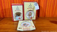 Three boxed Royal Doulton Bunnykins items on table